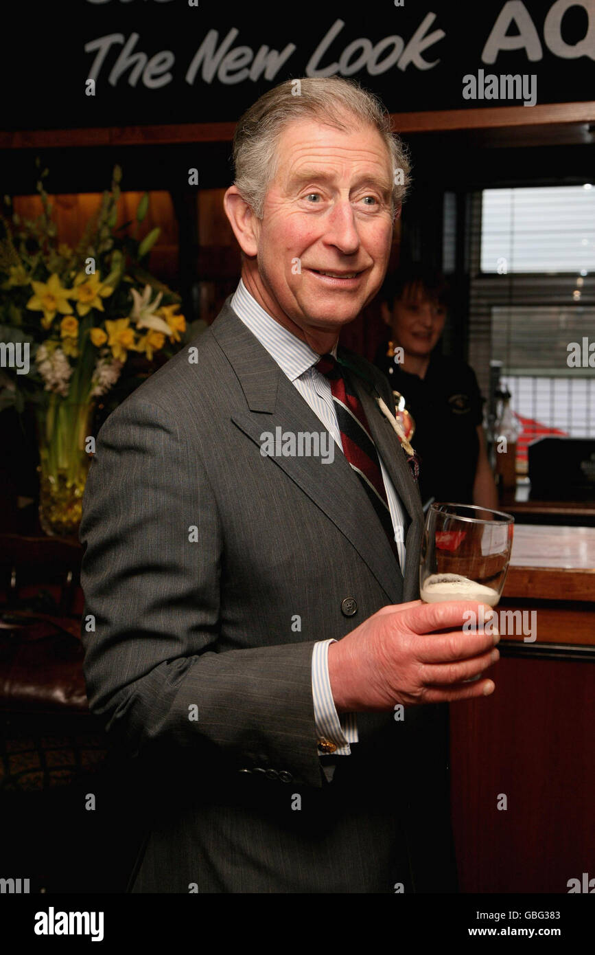The Prince of Wales holds a pint of beer at The Viaduct Pub during his visit to Froncysyllte, winner of the Calor Gas Village of the Year, near Clwyd in Wrexham, Wales. Stock Photo