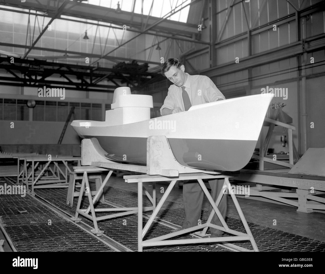 Geoffrey Wenban of Bolton, an Assistant Experimental Officer prepares a trawler model for test at the new Ship Hydrodynamics Laboratory at Feltham, Middlesex. Stock Photo