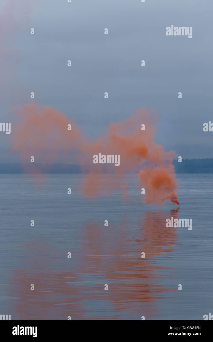Orange smoke on the water Stock Photo - Alamy