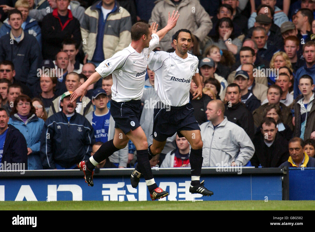 l-r; Bolton Wanderers' Kevin Nolan celebrates with opening goalscorer Youri Djorkaeff Stock Photo