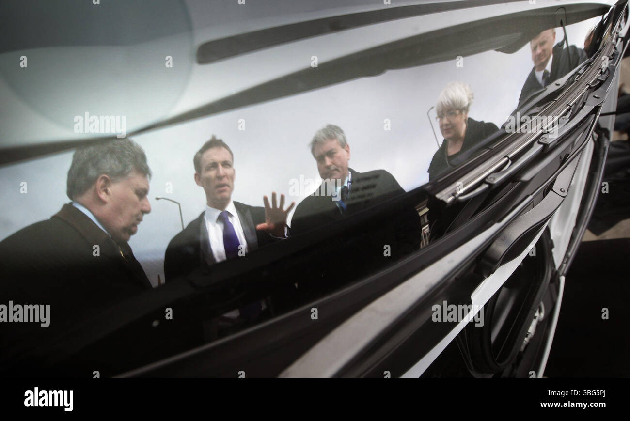 Left to right. Allied Vehicles Managing Director Paul Nelson, Scottish Secretary Jim Murphy, Scottish Labour Leader Iain Gray, MSP Patricia Ferguson and Allied Vehicles Marketing General Manager Donald Pow are seen reflected in the window of an electric car by Scottish company Allied Vehicles in Dundee. Stock Photo