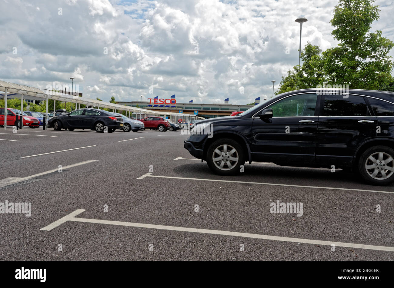 supermarket car park with white fluffy clouds Stock Photo