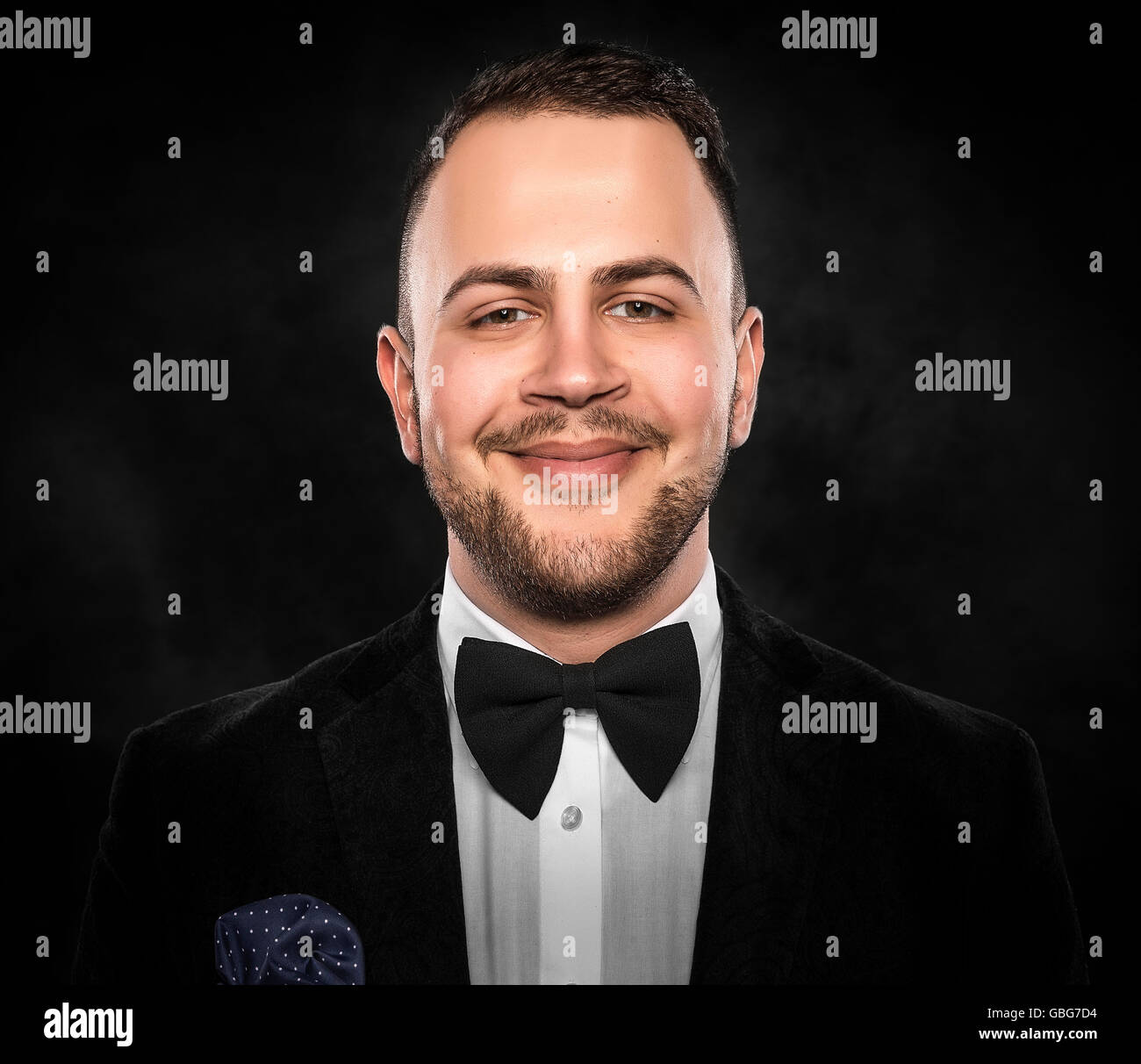 Young handsome man in black suit on dark background Stock Photo - Alamy