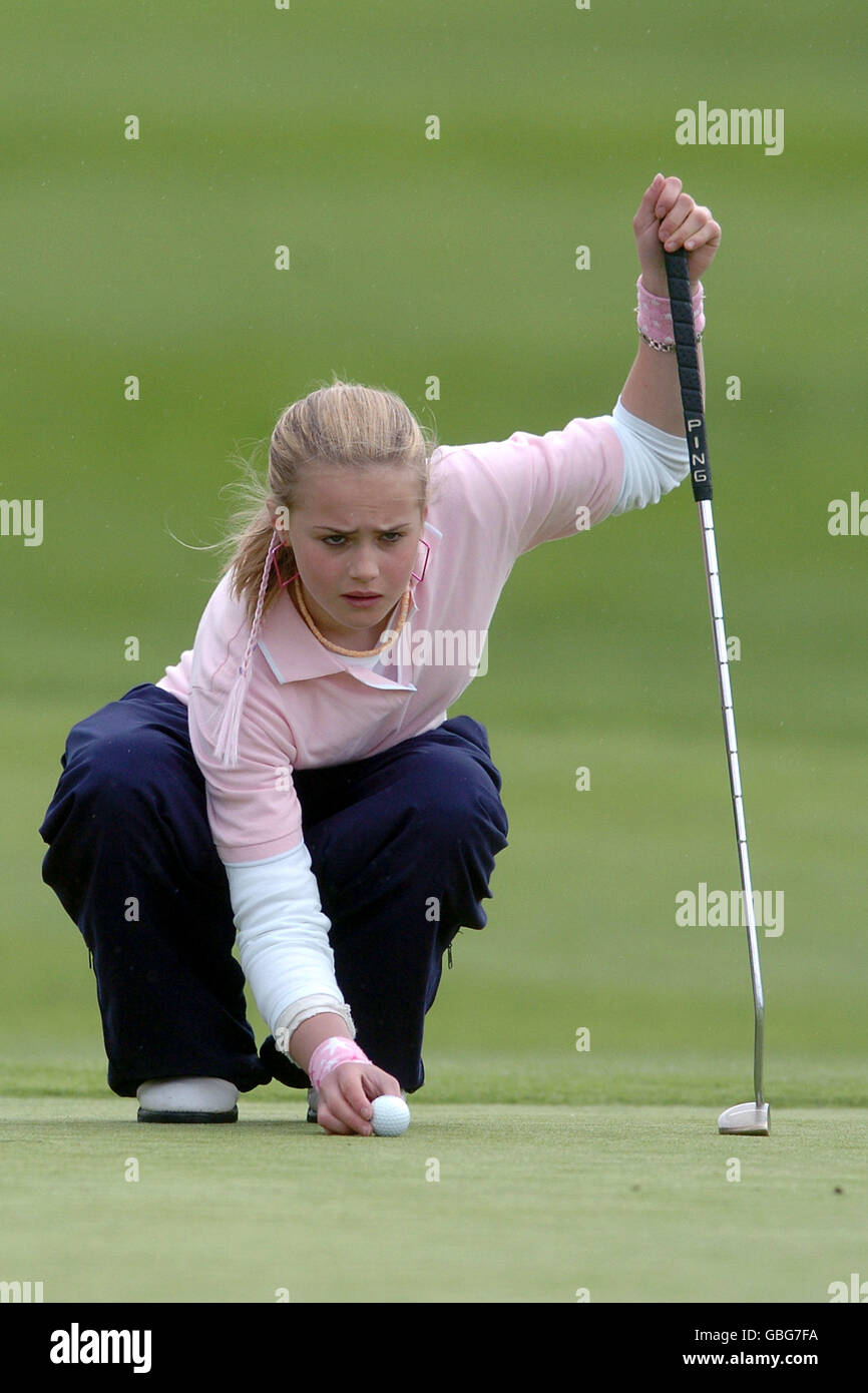 Golf - Damovo British Masters - Marriott Forest of Arden - First Round. Eleven year old Carly Booth places the ball for a putt Stock Photo