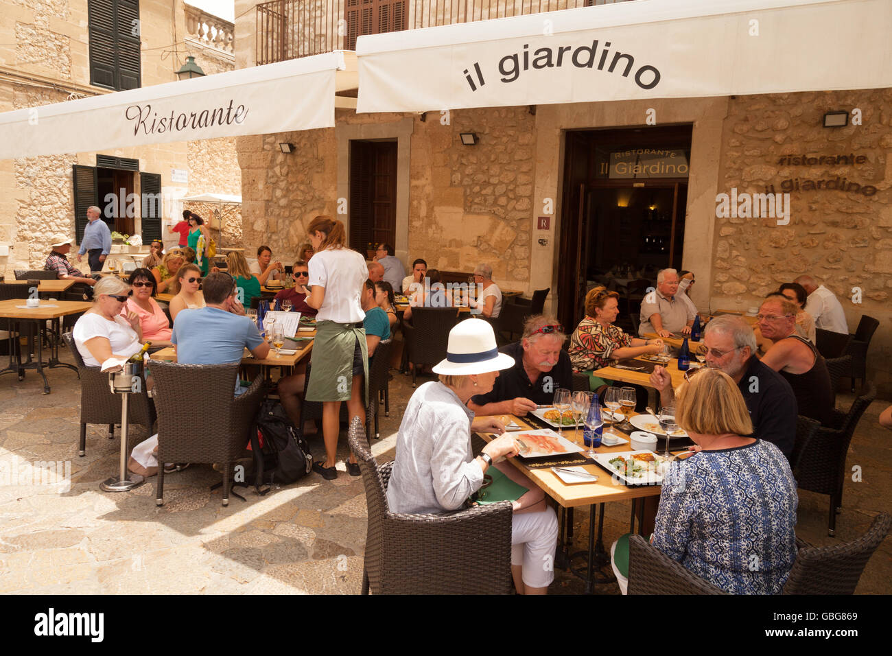 People eating and drinking outdoors at a restaurant, Alcudia, Mallorca ( Majorca ), Balearic Islands, Spain Europe Stock Photo