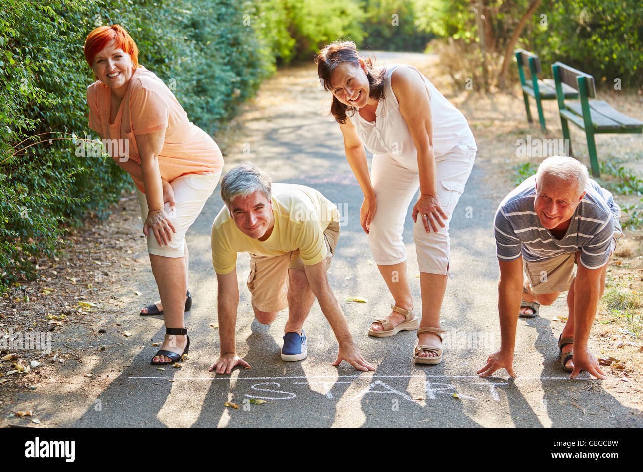 Group of seniors at the sart point of a race in summer at the park Stock Photo