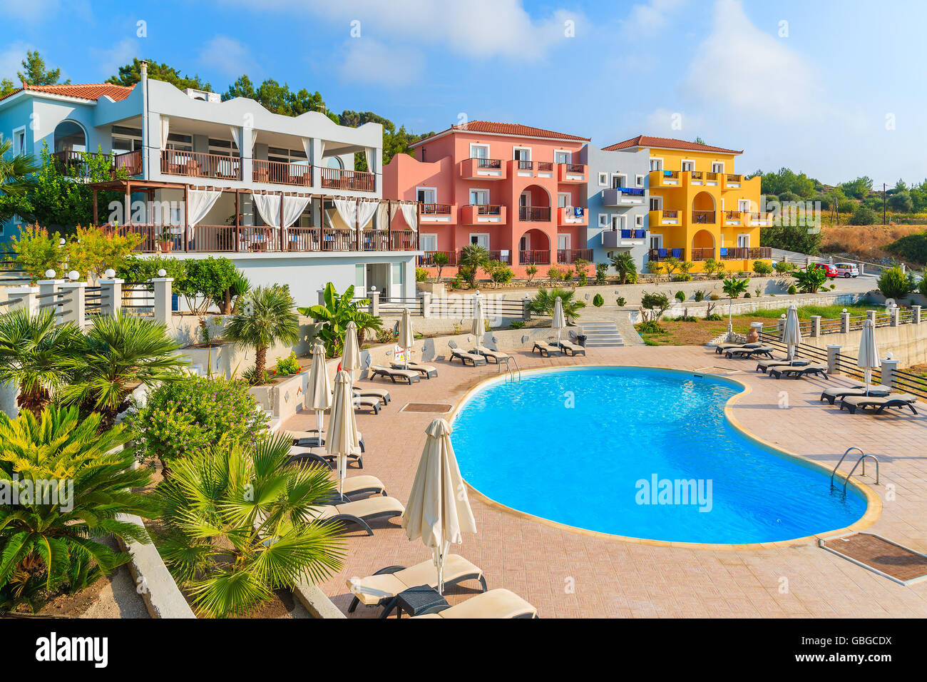SAMOS ISLAND, GREECE - SEP 20, 2015: view of swimming pool and colorful hotel buildings on sunny summer day, Samos island, Greec Stock Photo