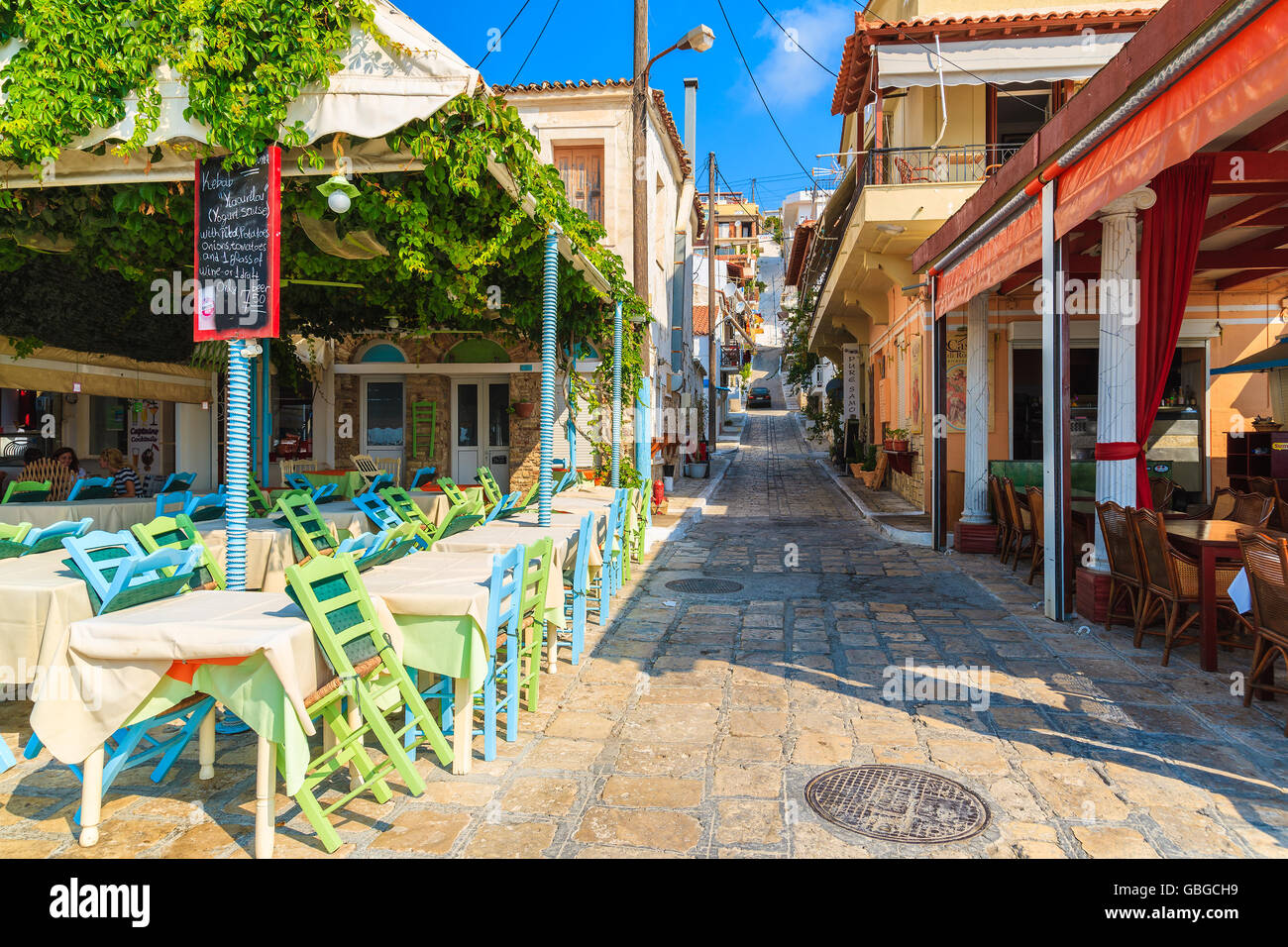 PYTHAGORION PORT, SAMOS ISLAND - SEP 19, 2015: street with traditional restaurants in Greek village of Pythagorion on Samos isla Stock Photo