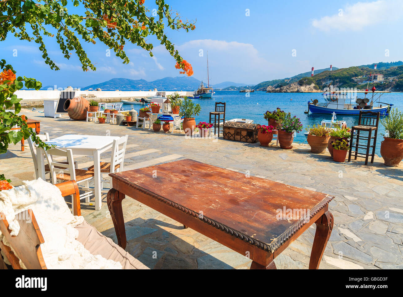 View of fishing boats anchoring in Kokkari bay from typical Greek tavern, Samos island, Greece Stock Photo