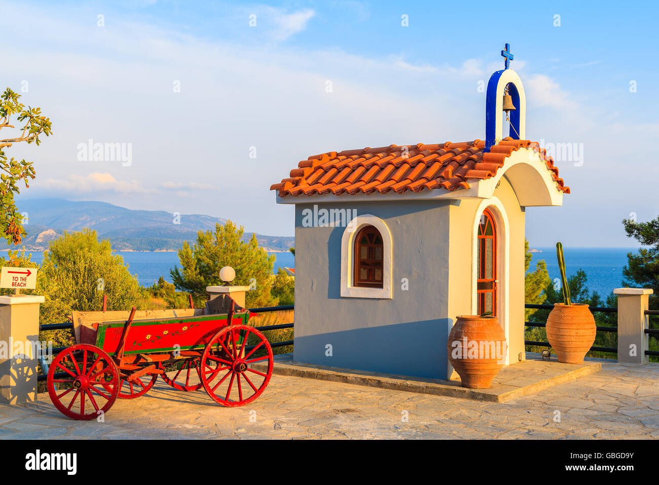 Small Greek chapel on coast of Samos island in warm sunset light, Greece Stock Photo