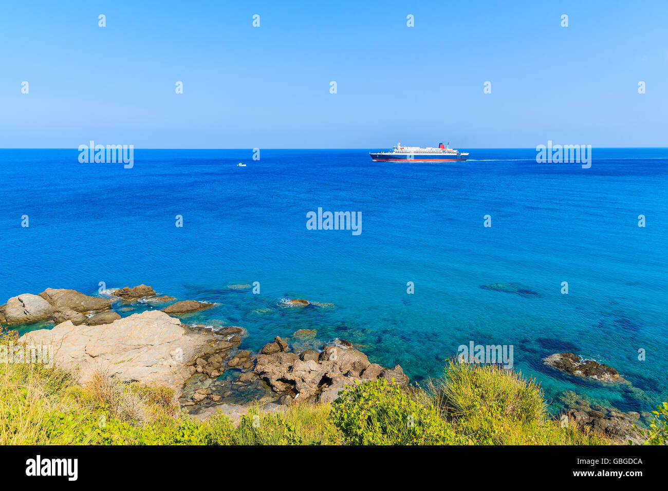 Ferry ship on blue sea sailing along coast of Samos island, Greece. Stock Photo