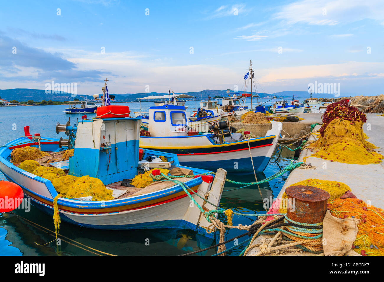 Colourful Greek fishing boats at sunset in small port, Samos island, Greece Stock Photo