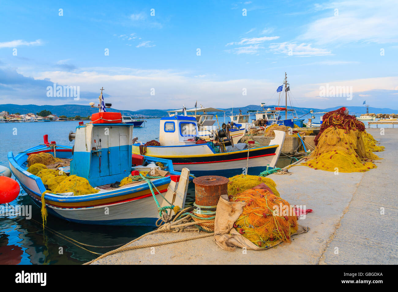 Typical Greek fishing boats in port at sunset time, Samos island, Greece Stock Photo