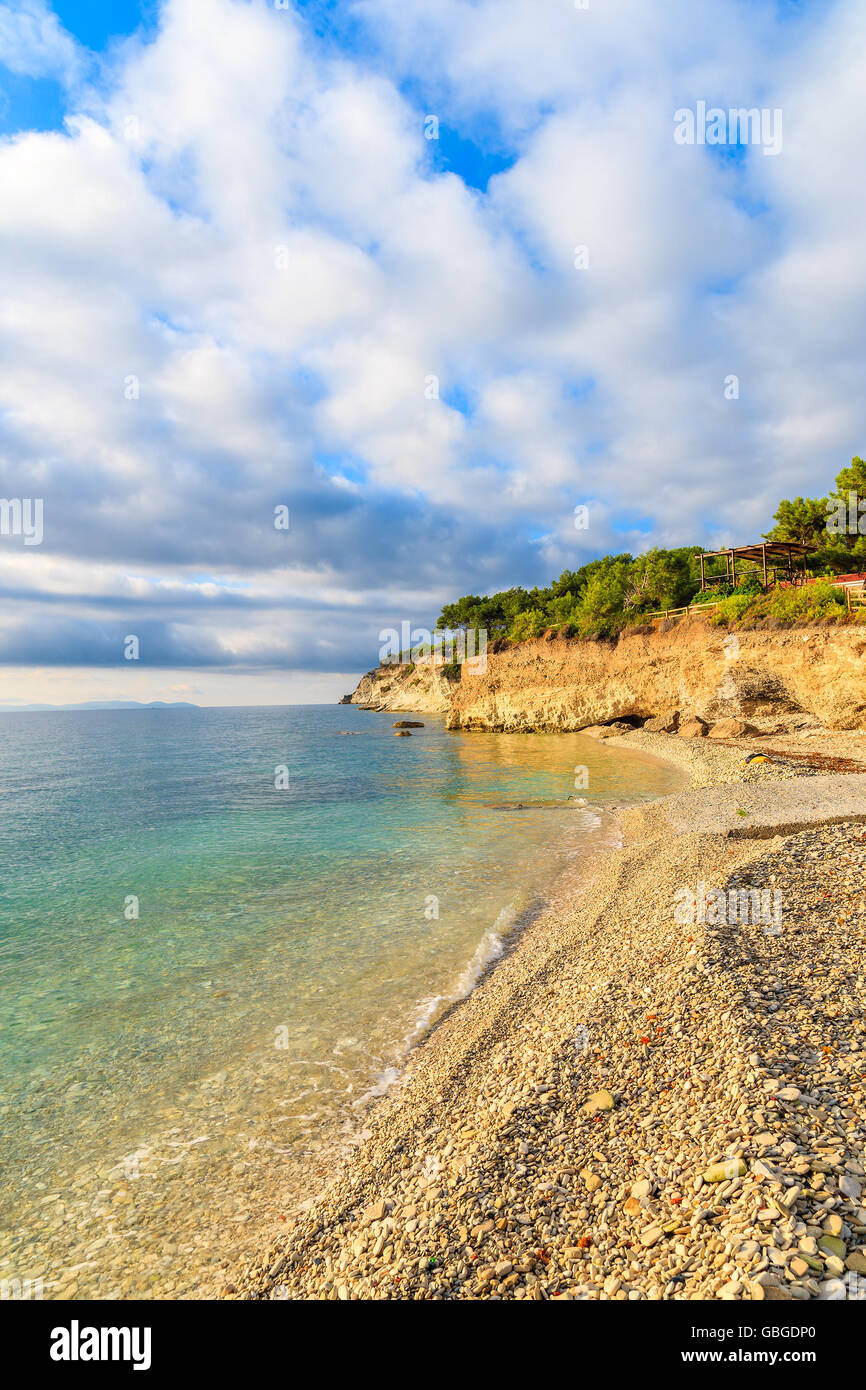 View of beach with beautiful clouds on blue sky, Samos island, Greece Stock Photo