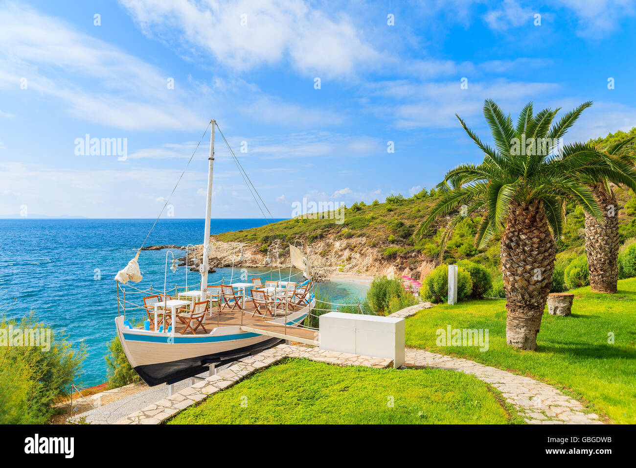 Traditional sailing boat in green area of Proteas bay on coast of Samos island, Greece Stock Photo