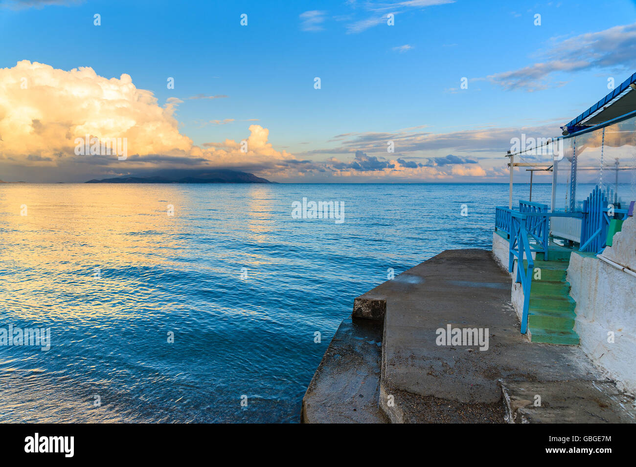 Greek restaurant on beach at sunset time, Samos island, Greece Stock Photo