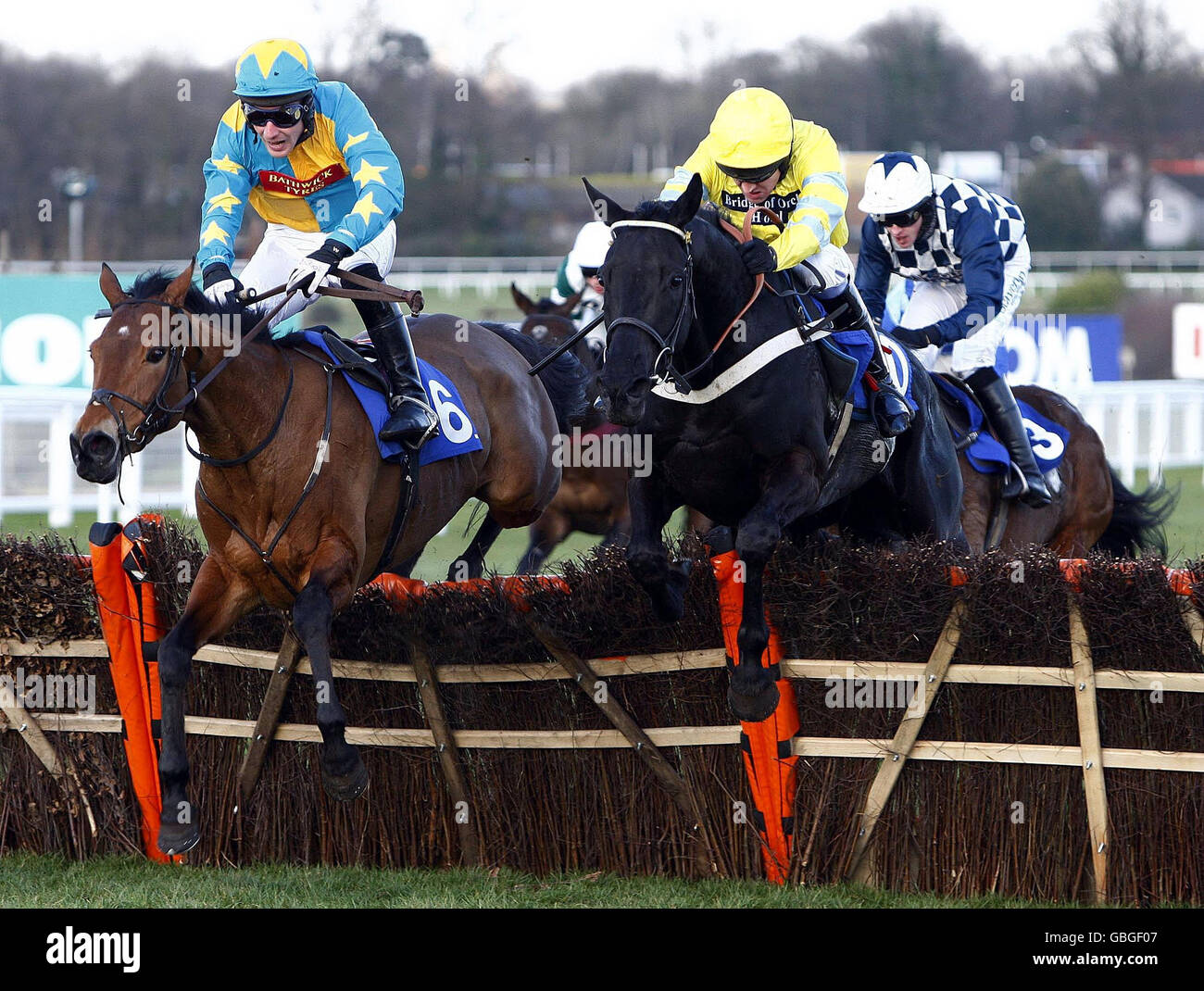 Don't Tell The Wife ridden by Barry Geraghty (yellow cap) goes on to win the Charles Stanley group plc countryside alliance handicap hurdle race at Sandown Park Racecourse, Surrey. Stock Photo