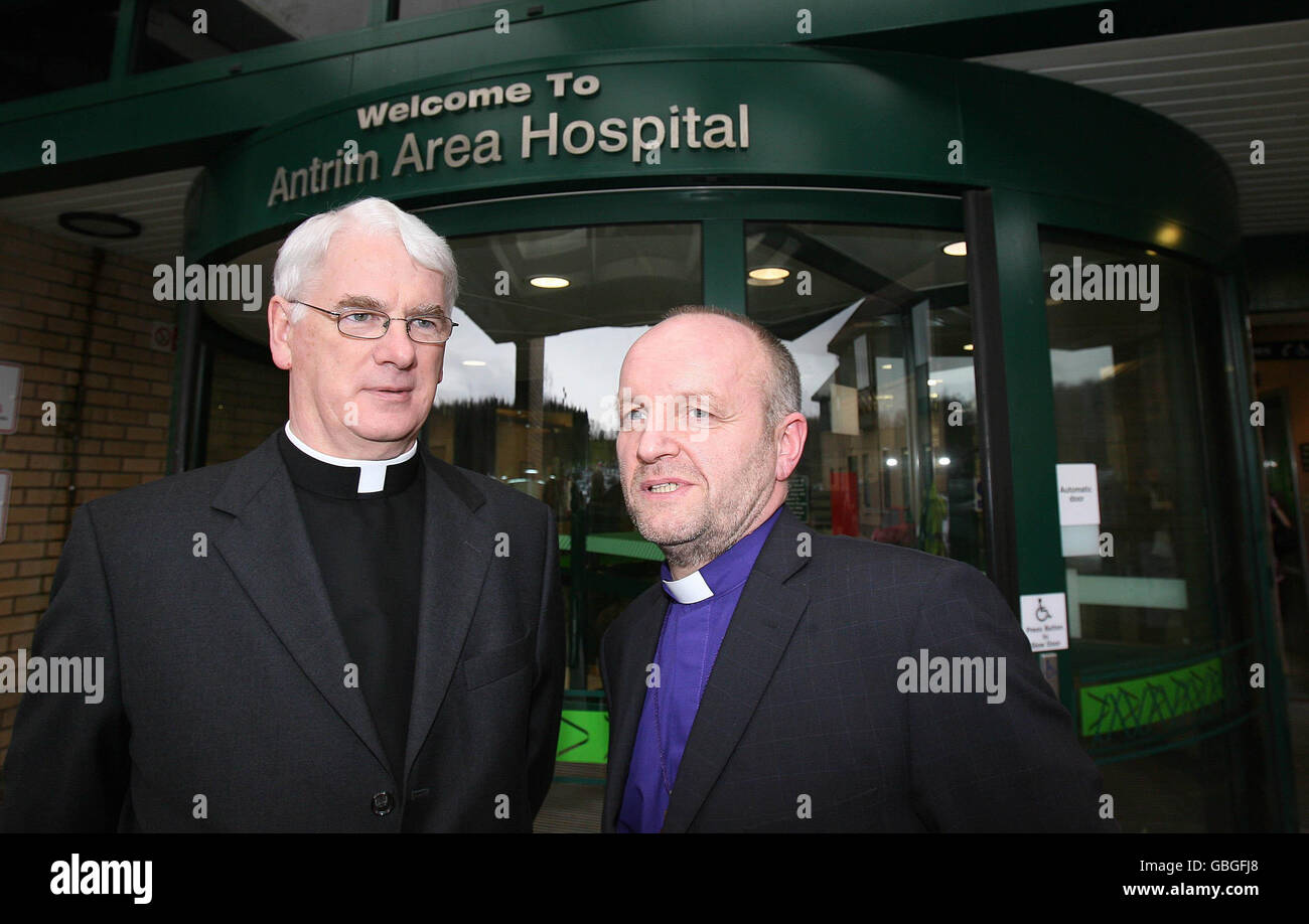 Catholic Bishop of Down and Connor Noel Treanor (left) and Church of Ireland Bishop of Connor Rev Alan Abernethy outside Antrim Area hospital after they spoke medical staff and visited those injured in Saturdays Real IRA gun attack at Masereene Barracks in Co Antrim. Stock Photo