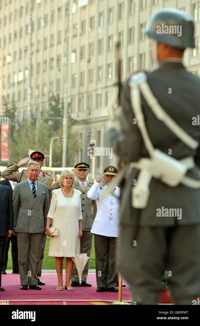 The Prince of Wales and the Duchess of Cornwall stand to attention, as the national anthems of Chile and Britain are played at the Monument to Bernardo O'Higgins, in the Main square in Santiago Chile. Stock Photo