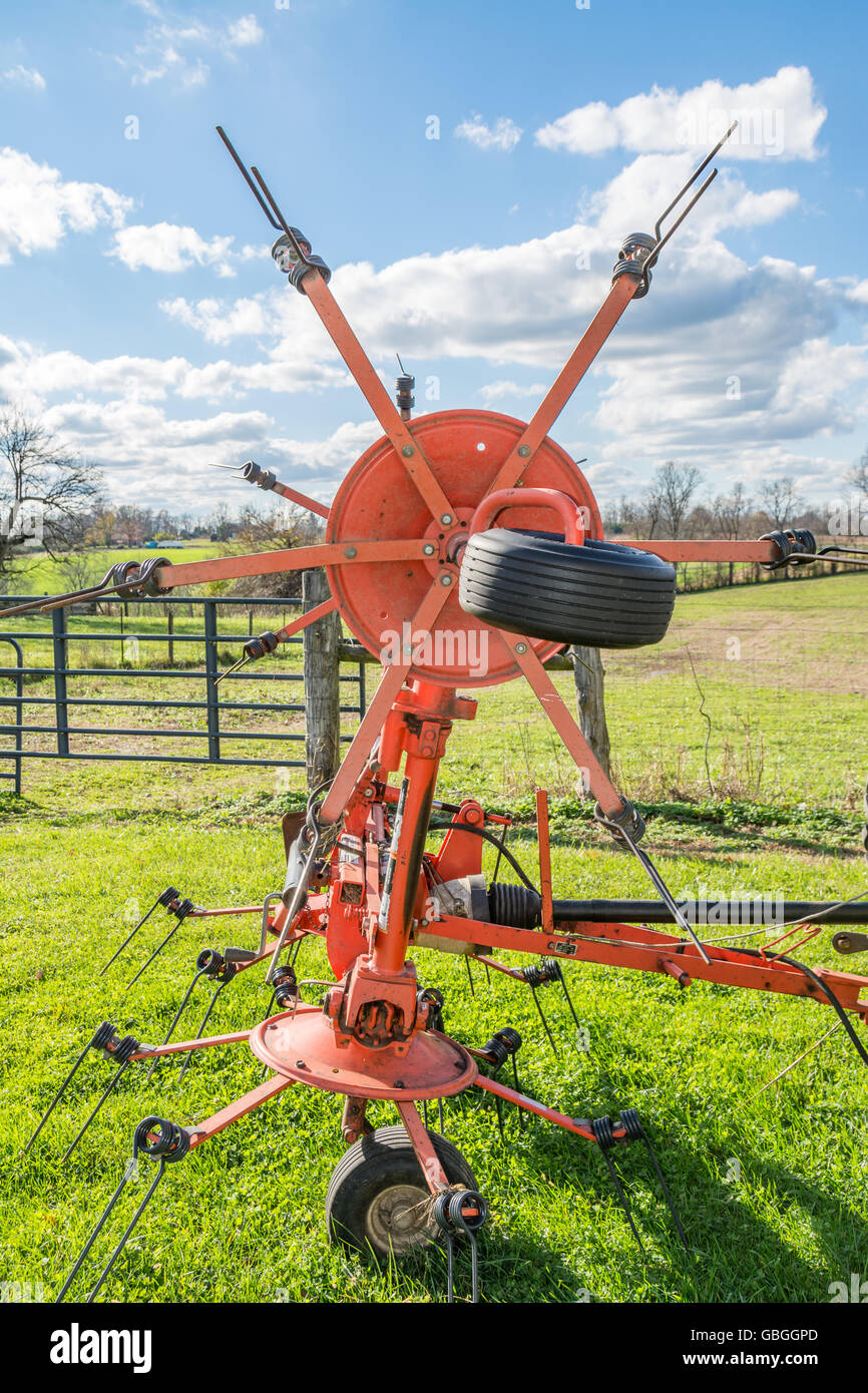 Agricultural hay rake used to fluff up the hay and turn it over so that it can dry and to collect the hay into windrows Stock Photo