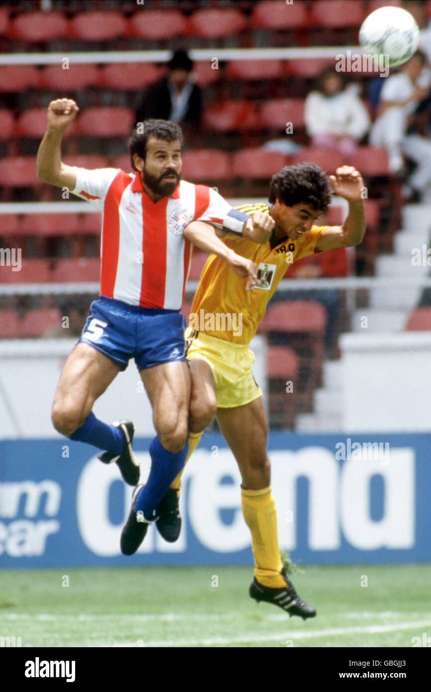 Paraguay's Rogelio Delgado (l) heads clear from Iraq's Ahmed Radhi (r) Stock Photo