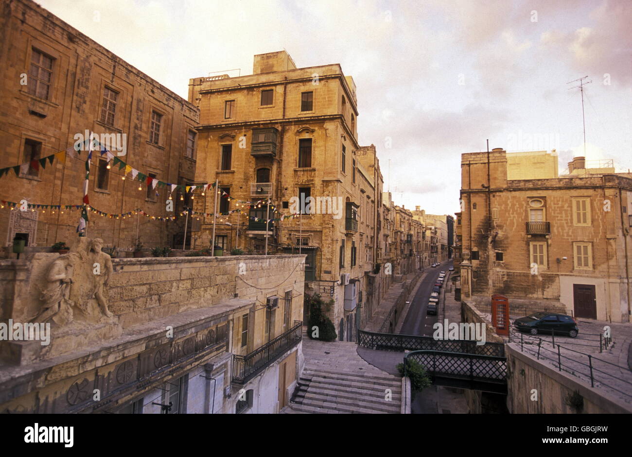 A smal road in the centre of the Old Town of the city of Valletta on the Island of Malta in the Mediterranean Sea in Europe. Stock Photo