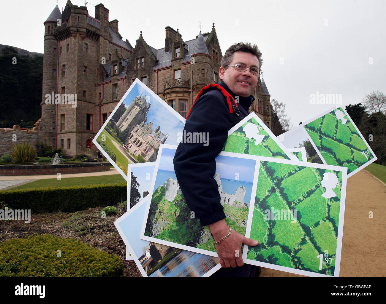 Royal Mail postman Stephen Hunsdale at the launch of Royal Mail's new designs for a set of Royal Mail stamps depicting the Castles of Northern Ireland, at Belfast Castle. Stock Photo