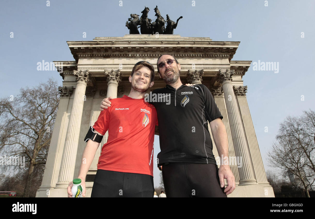Jack Jones (red top) and his American team mate Chris Cuddihy in front of  the Wellington Arch in Hyde Park Corner after completing the 777 Ultra  Marathon Challenge. The British runner set