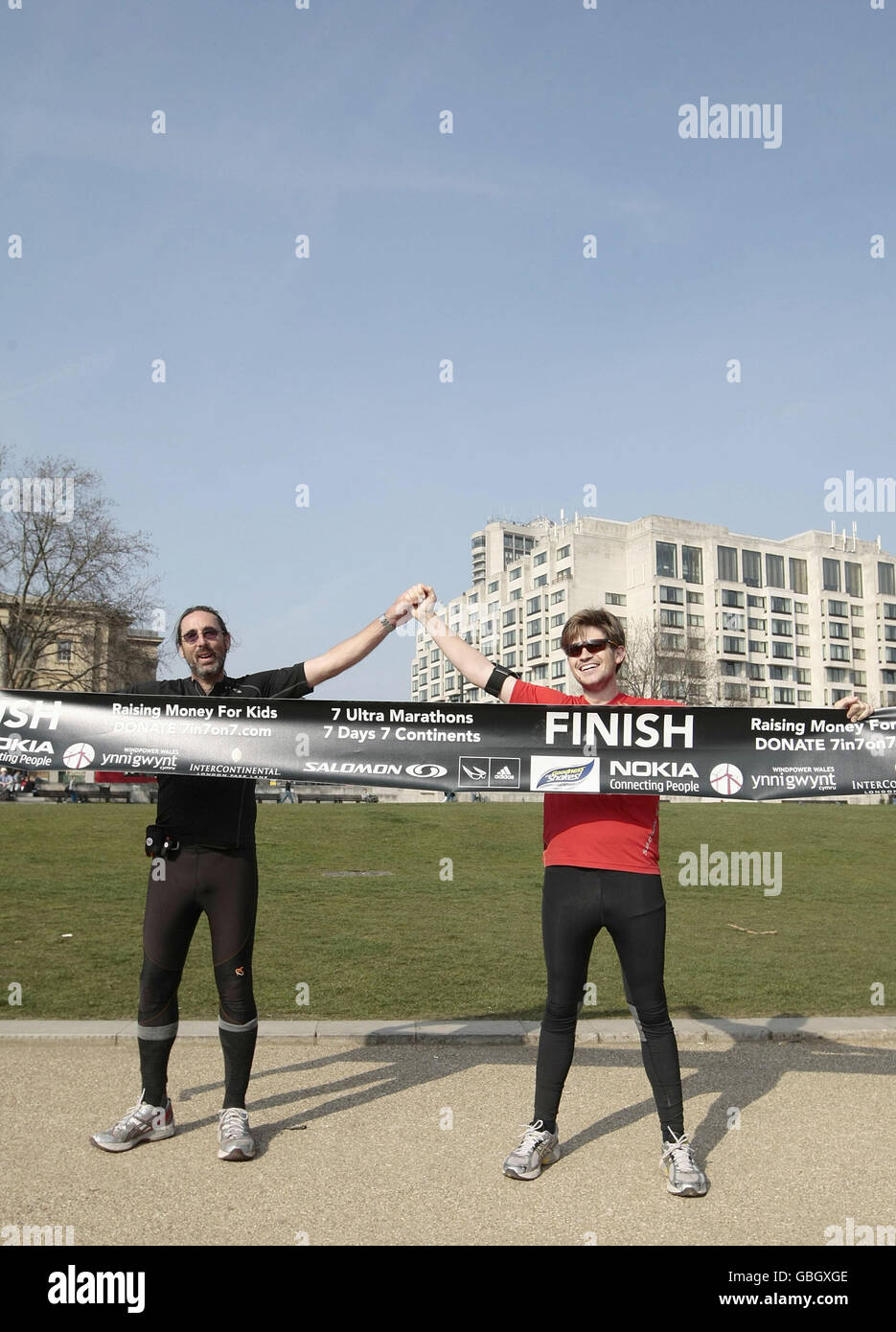 Jack Jones (red top) and his American team mate Chris Cuddihy celebrate in  Hyde Park after completing the 777 Ultra Marathon Challenge. The British  runner set a world record for completing seven