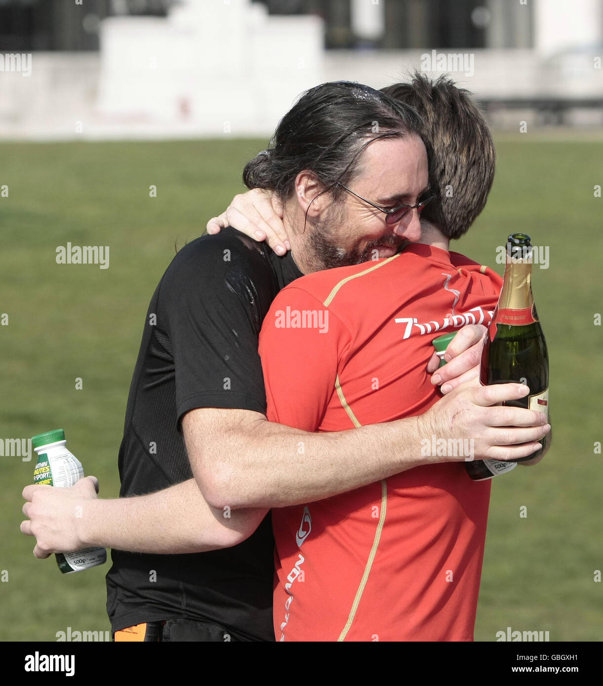 Jack Jones (red top) and his American team mate Chris Cuddihy celebrate in  Hyde Park after completing the 777 Ultra Marathon Challenge. The British  runner set a world record for completing seven