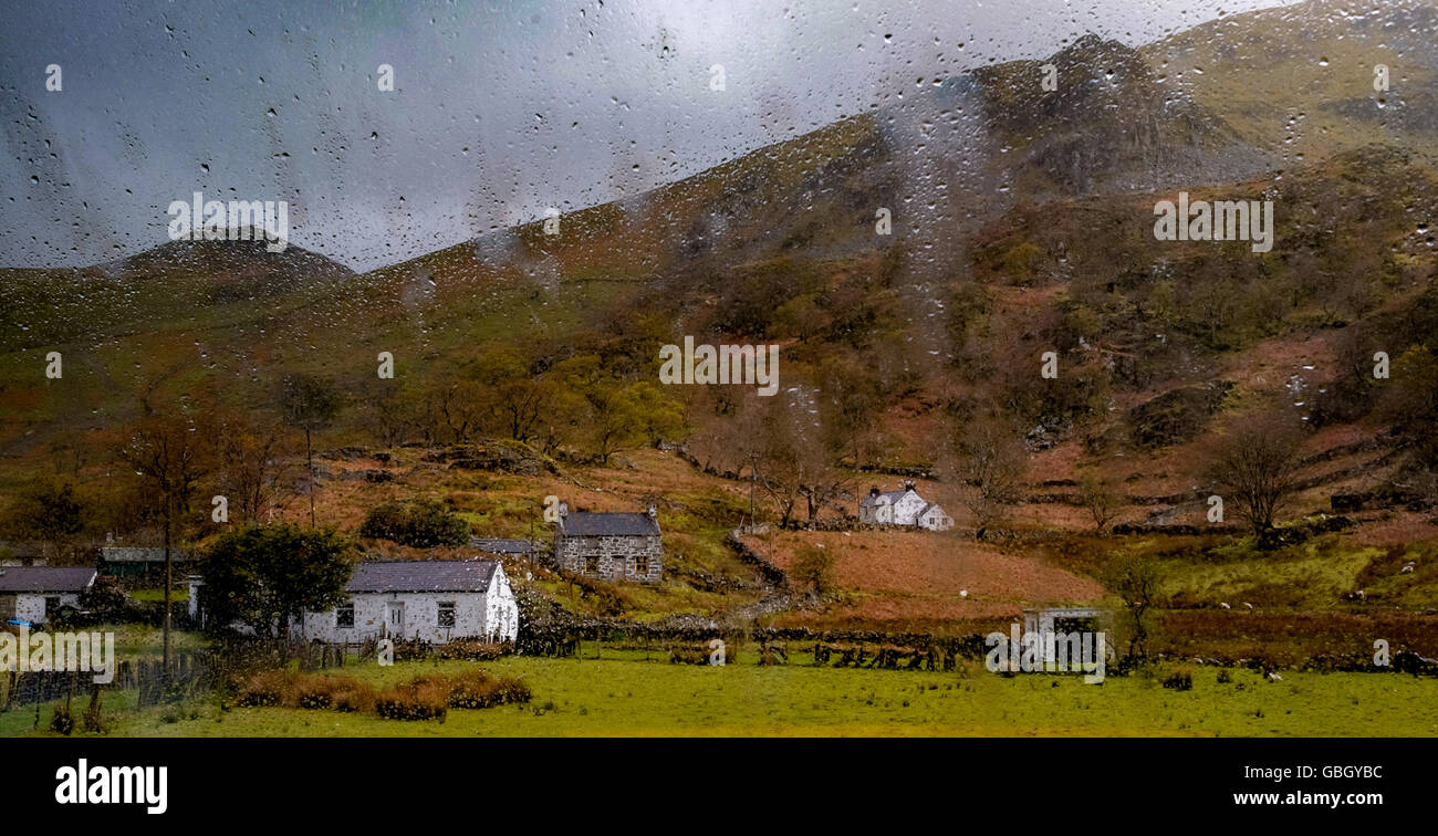 View of snowdonia cottages at Snowdon through wet window Stock Photo