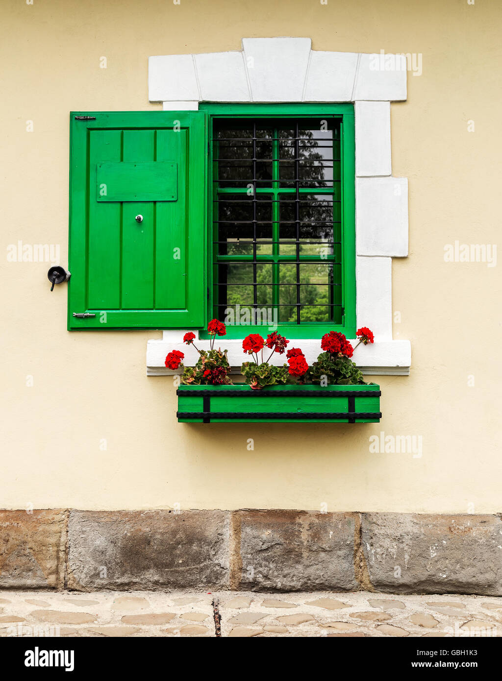 Green window with flower box and shutters Stock Photo Alamy