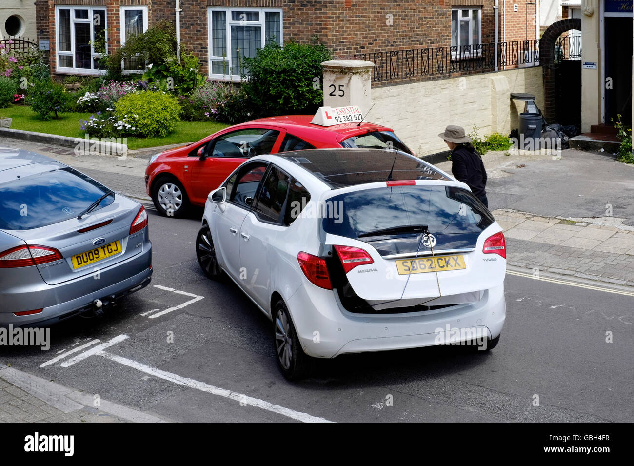 female driver blocked in by an illegally parked learner parked on double yellow lines england uk Stock Photo