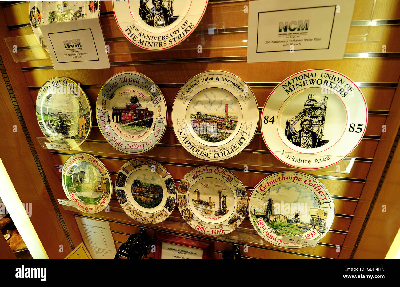 Commemorative plates of Coal Mining history, for sale at the National Mining Museum at Caphouse Colliery near Wakefield. A new plate commemorating the 25th Anniversary of the Miners Strike which began this month 25 years ago (top right) stands among others showing Pits that closed following the year long dispute. Stock Photo