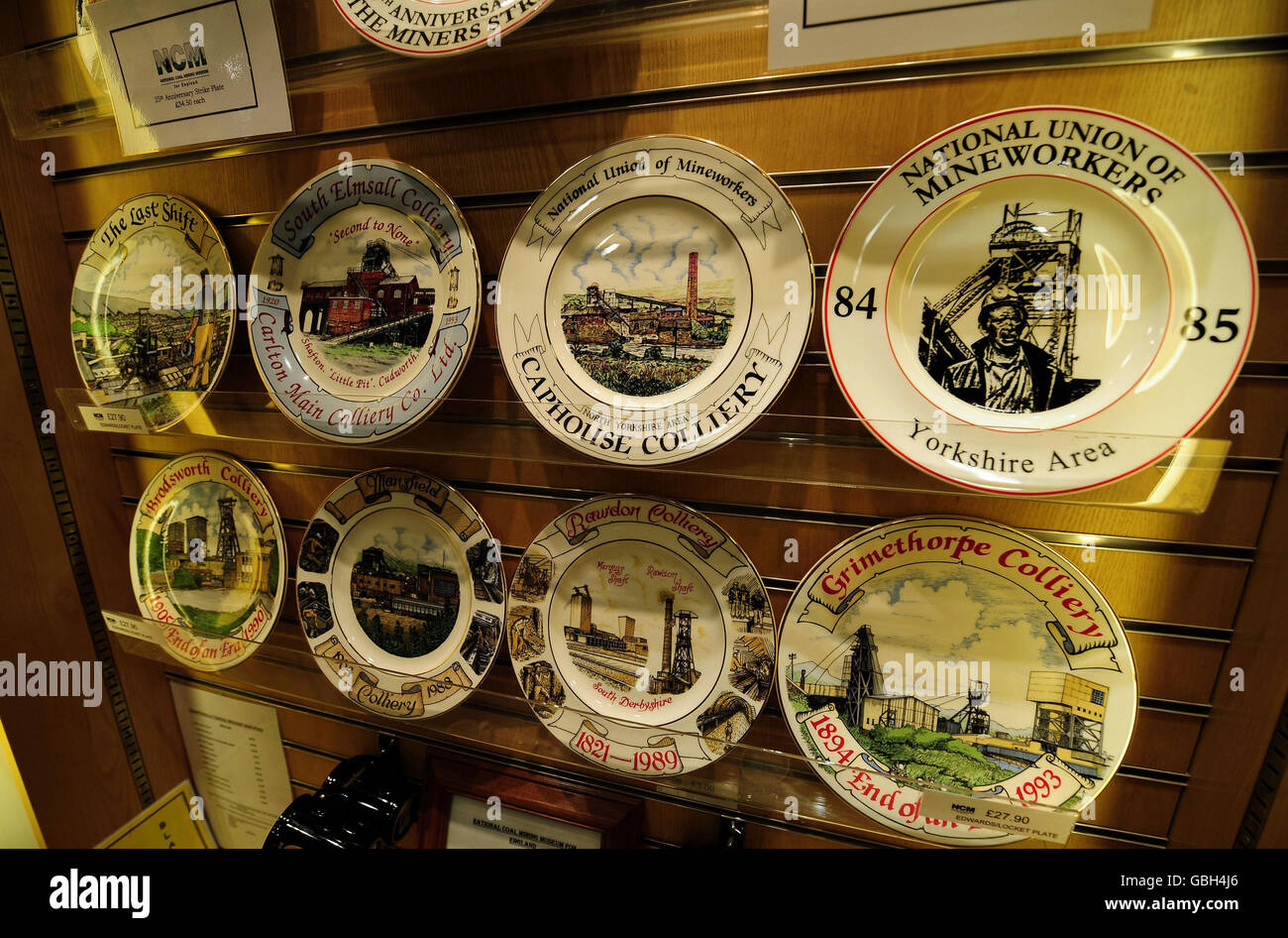Commemorative plates of Coal Mining history, for sale at the National Mining Museum at Caphouse Colliery near Wakefield. A new plate commemorating the 25th Anniversary of the Miners Strike which began this month 25 years ago (top right) stands among others showing Pits that closed following the year long dispute. Stock Photo