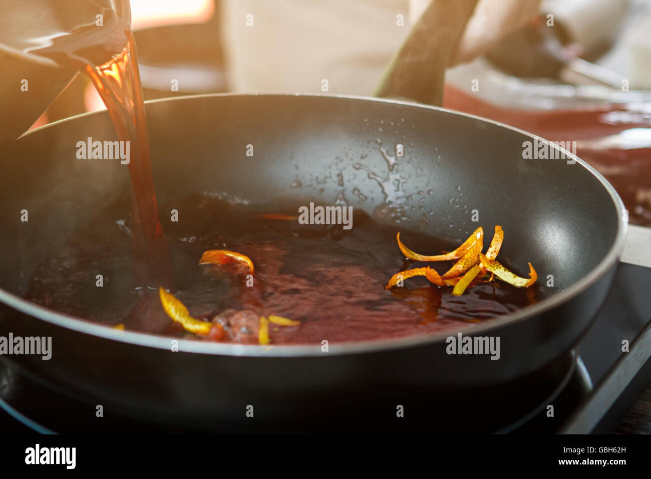 Red liquid pouring onto pan Stock Photo Alamy