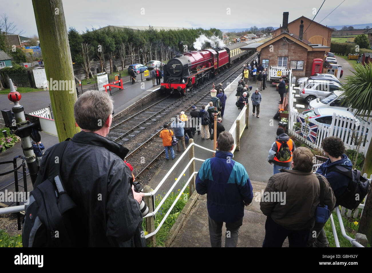 Railway enthusiasts gather to take pictures and gaze at the recently restored LMS 6100 Royal Scot steam engine at Bishop's Lydeard train station on its first day of four days taking part in the West Somerset Railway's Spring steam gala. Stock Photo