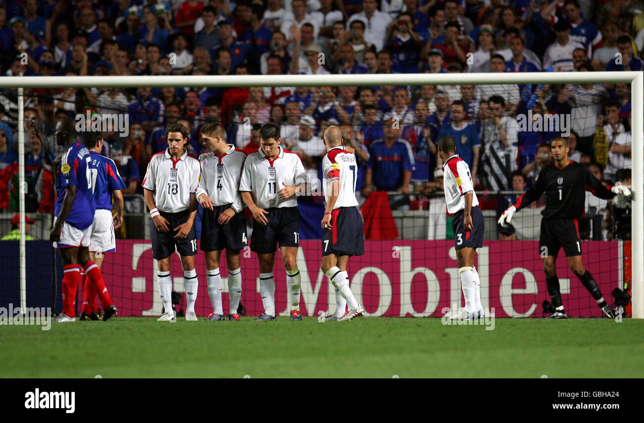 England's David James organises his defensive wall prior to France's Zinedine Zidane scoring the equalising goal Stock Photo