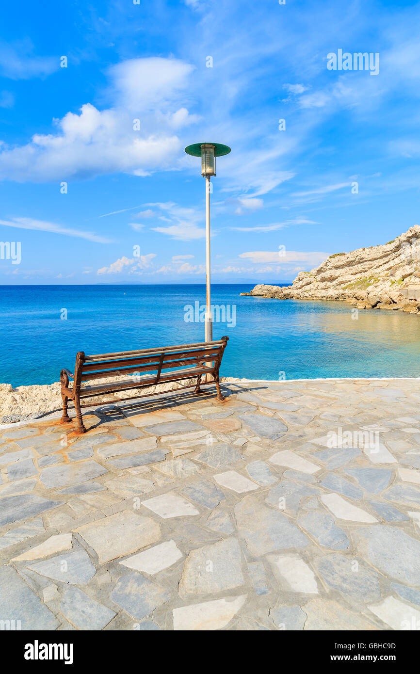 Bench on coastal promenade along Kokkari beach, Samos island, Greece Stock Photo