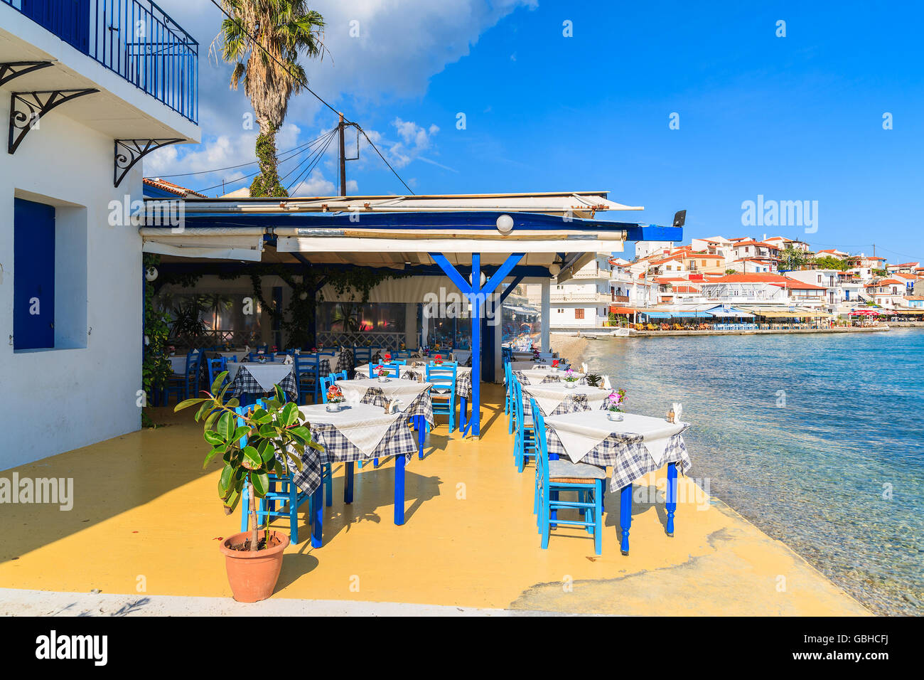 KOKKARI, SAMOS ISLAND - SEP 25, 2015: Tables with chairs in traditional Greek tavern in Kokkari town on coast of Samos island, G Stock Photo