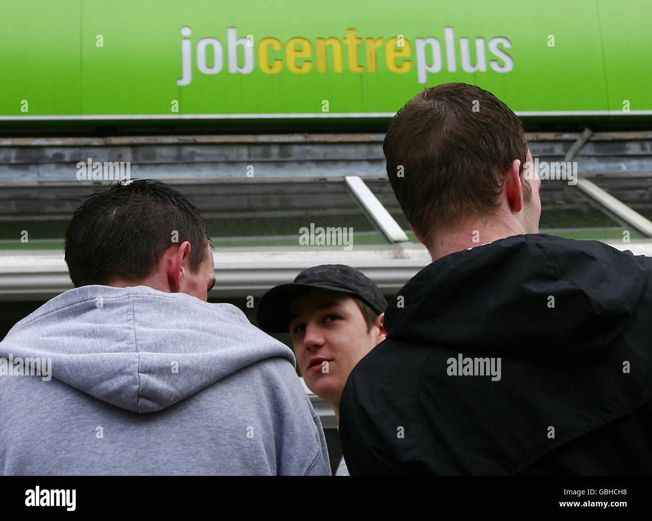 A group of men wait outside Chatham Job Centre Plus in Kent. Picture