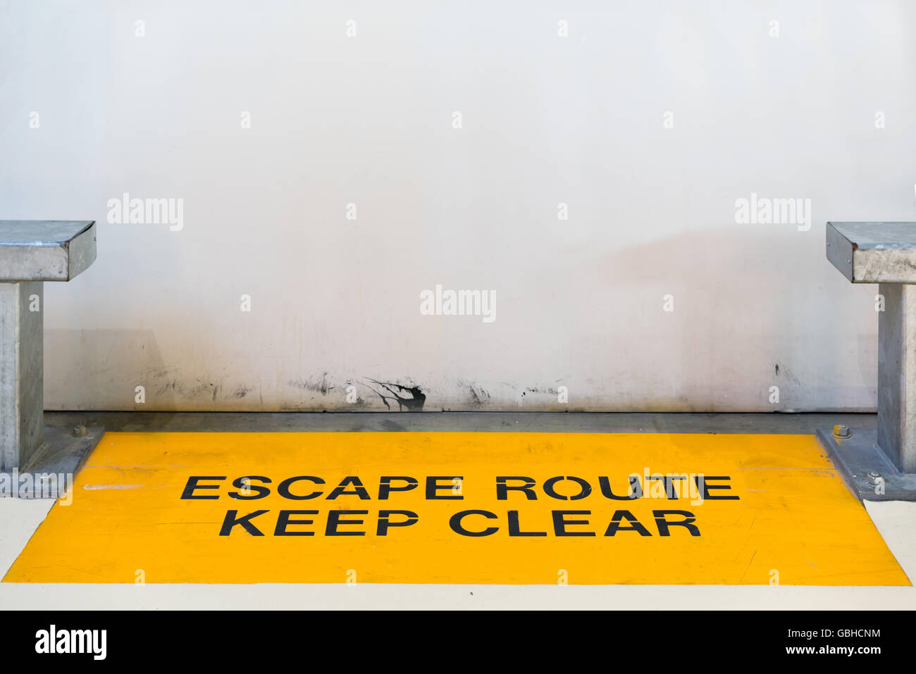 Escape route, keep clear sign blocked by concrete wall with copy space, clipping path for travel image adaptation Stock Photo