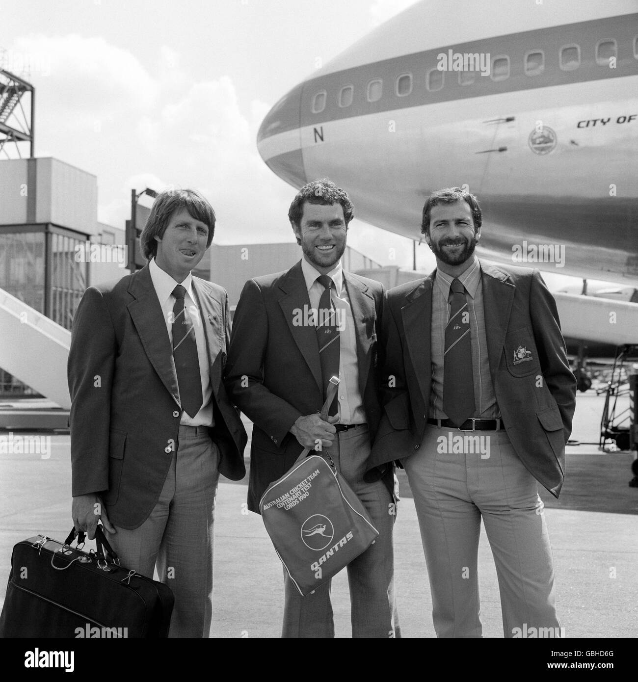 Australian cricket captain Greg Chappell flanked by fast bowlers Jeff Thomson, left, and Dennis Lillee at Heathrow Airport when they arrived in preparation for the Centenary Test against England. Stock Photo