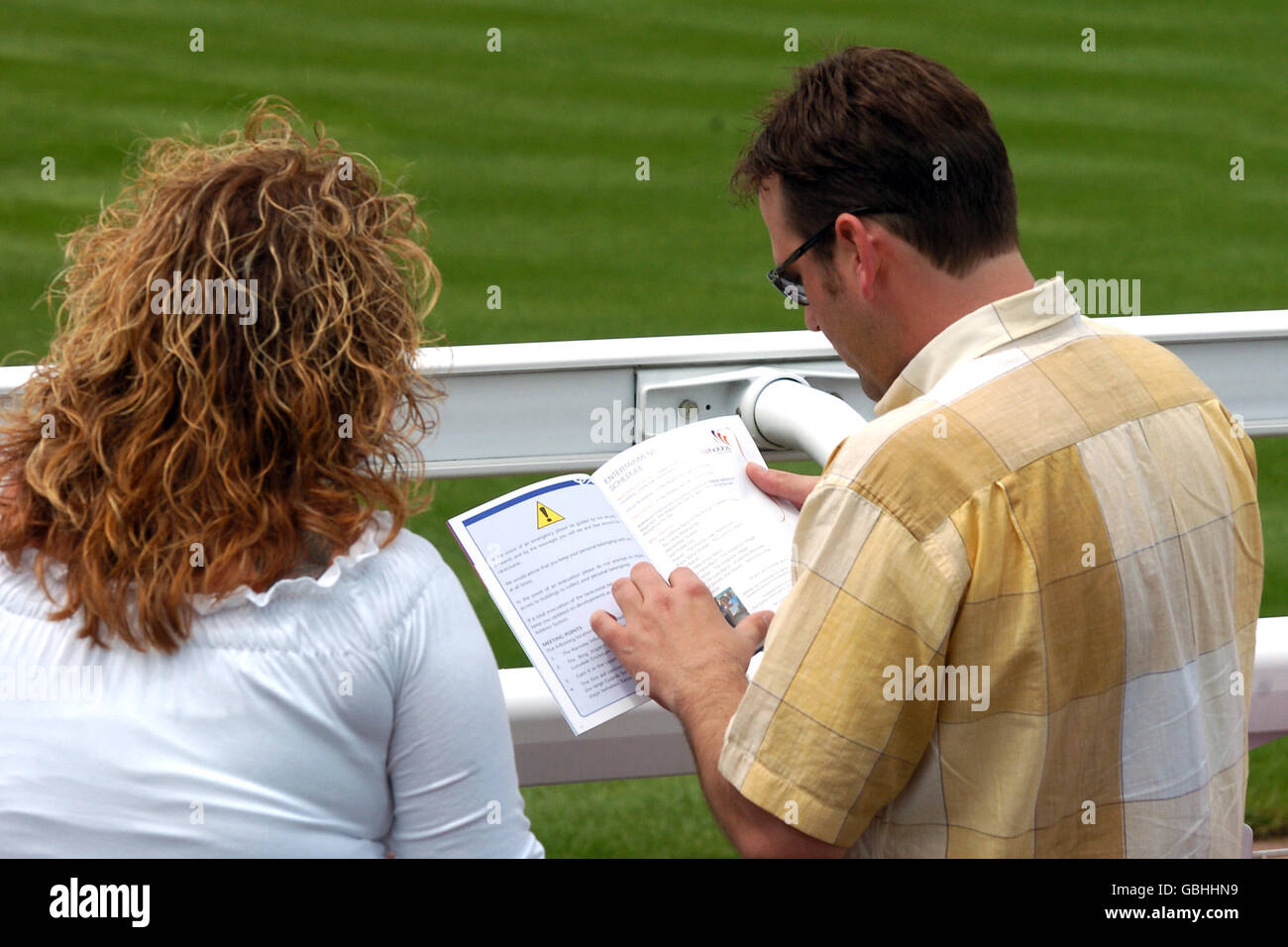 Horse Racing - Epsom Races - Vodafone Oaks Day. Racegoers study the ...