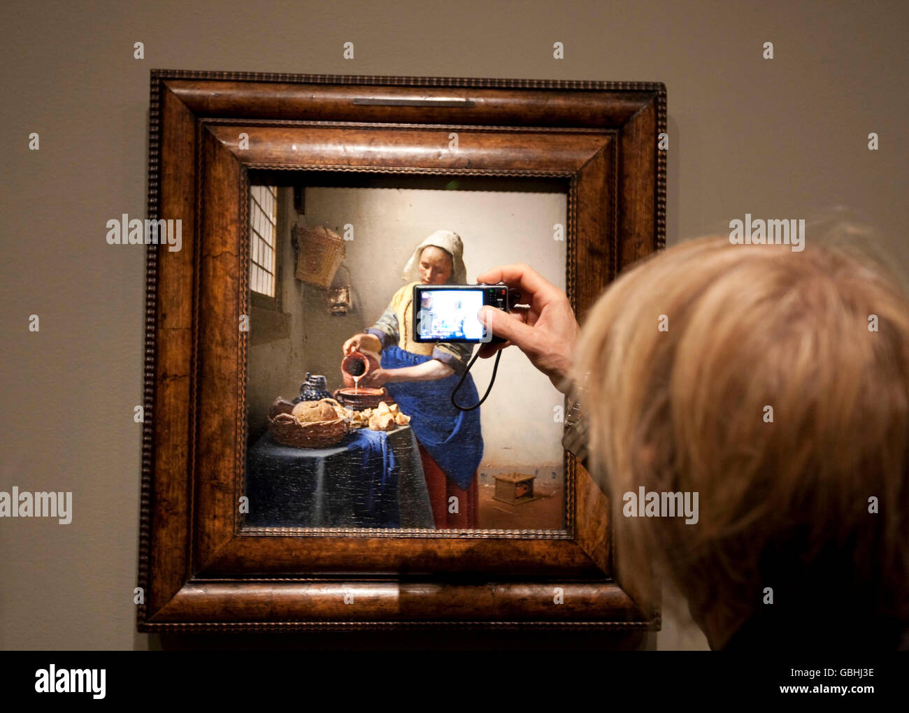 Someone photographs Vermeer's painting 'The Milkmaid' at the Metropolitan Museum of Art in New York, USA, 8 September 2009. Stock Photo