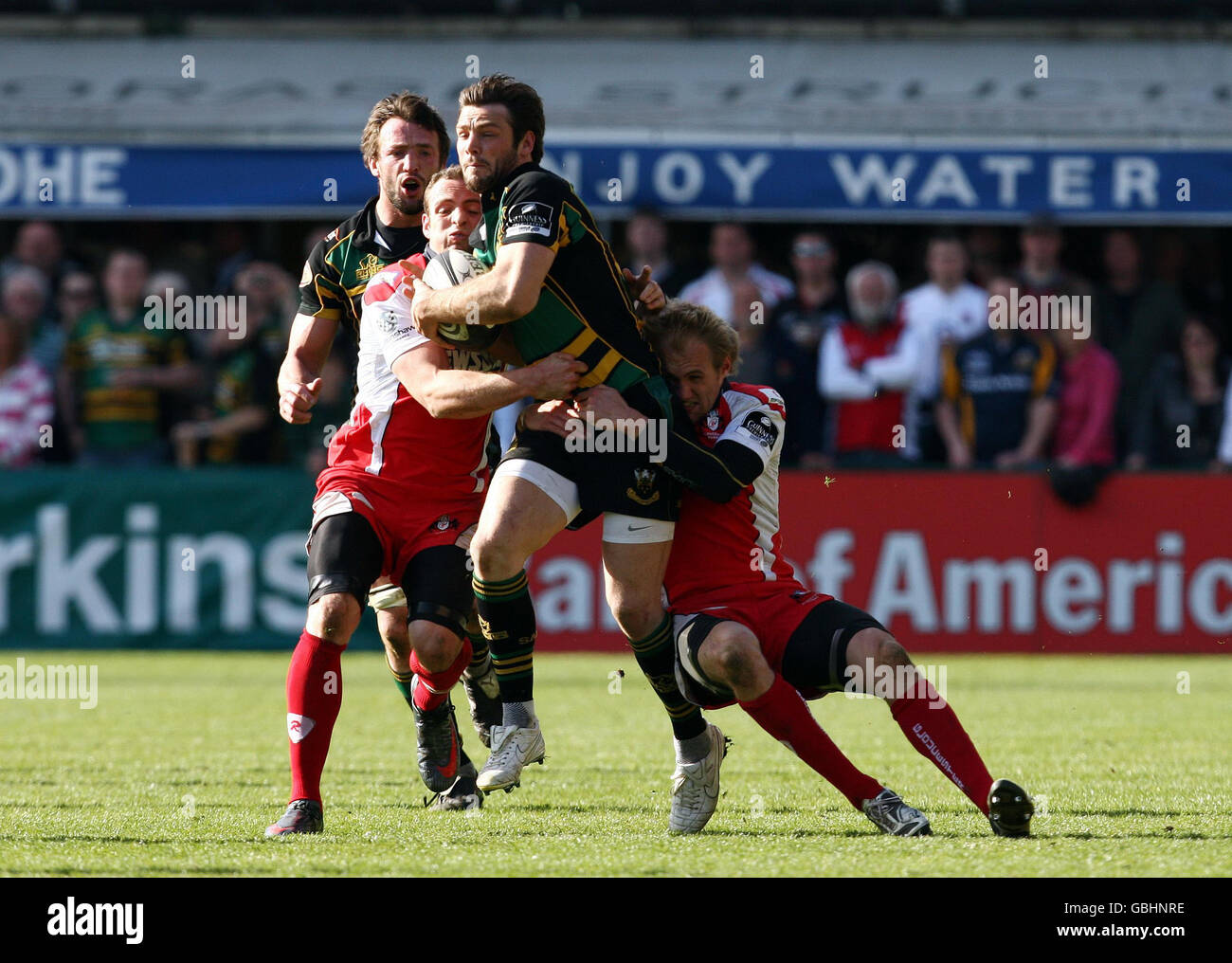 Northampton Saints' Ben Foden is tackled by Gloucester's Olly Morgan and Olly Barclay during the Guinness Premiership match at Franklins Gardens, Northampton. Stock Photo