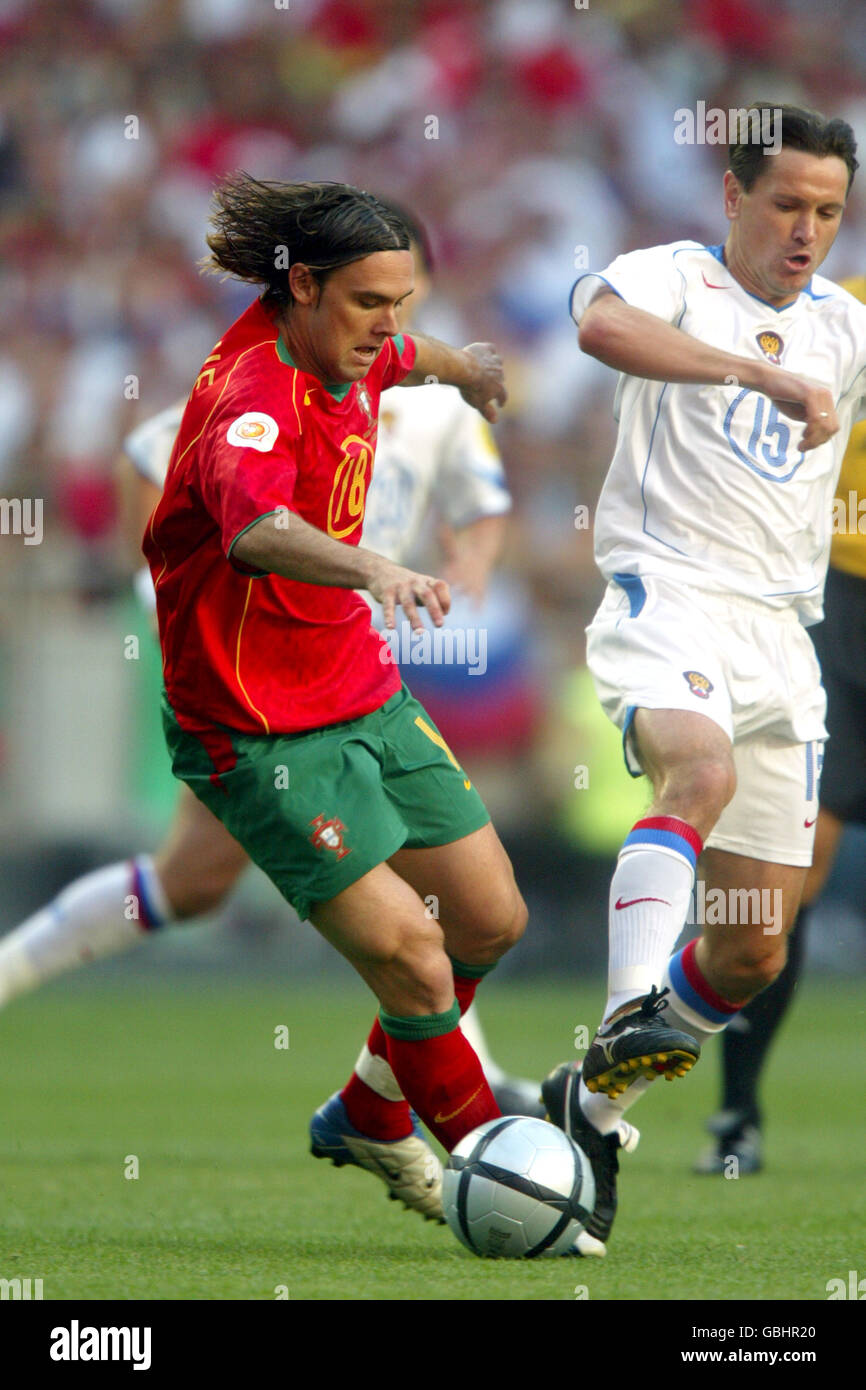 Soccer - UEFA European Championship 2004 - Group A - Russia v Portugal. Russia's Dmitri Alenichev (r) and Portugal's Maniche (l) battle for the ball Stock Photo