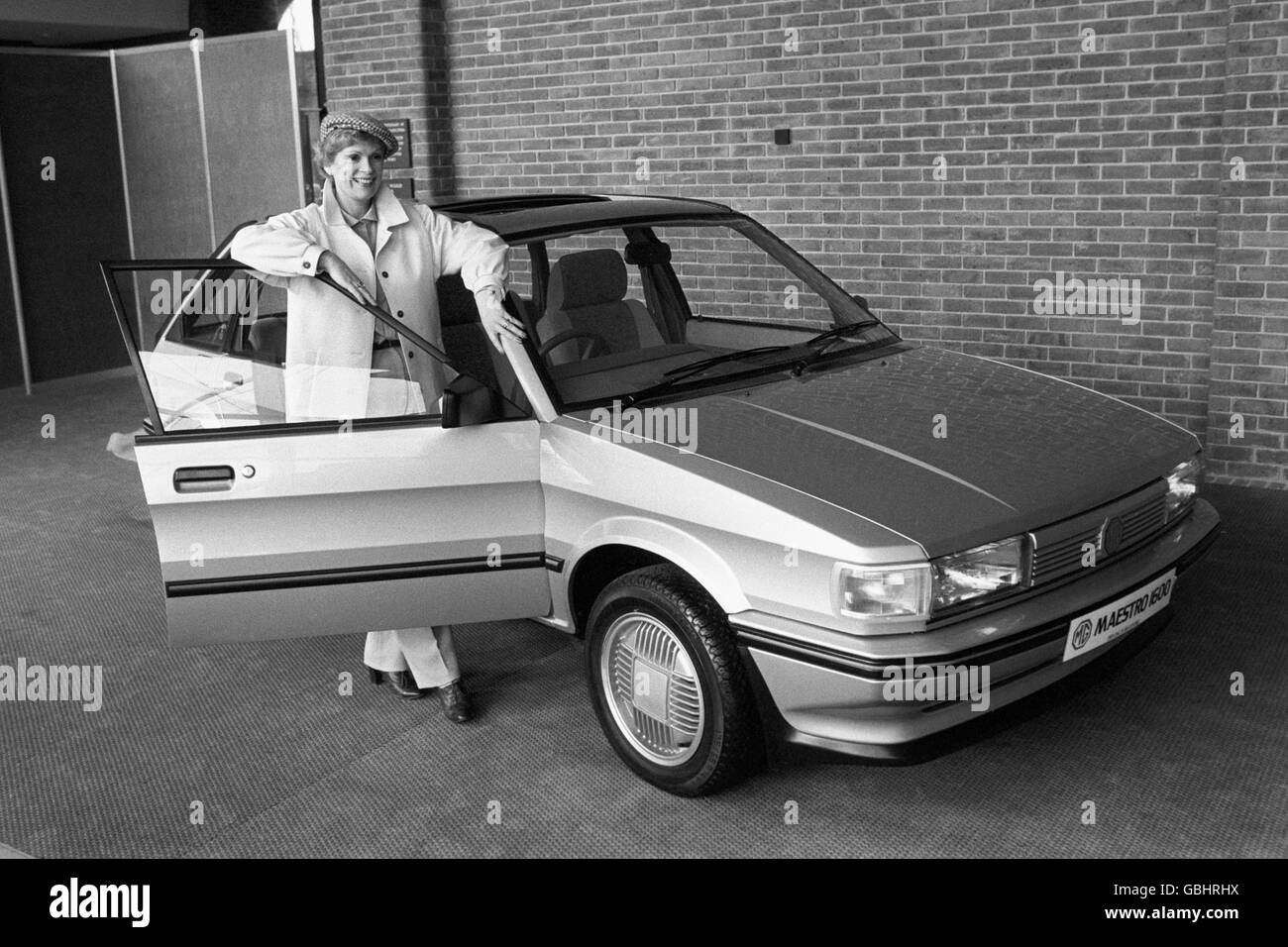 TV actress Nicolette McKenzie with the Austin Maestro MG 1600, when the seven-car range had its press launch at the World Trade Centre. The Maestro is the first European built volume car with a 'voice' - Miss McKenzie's. It talks through a larynx in its dashboard computer. Stock Photo