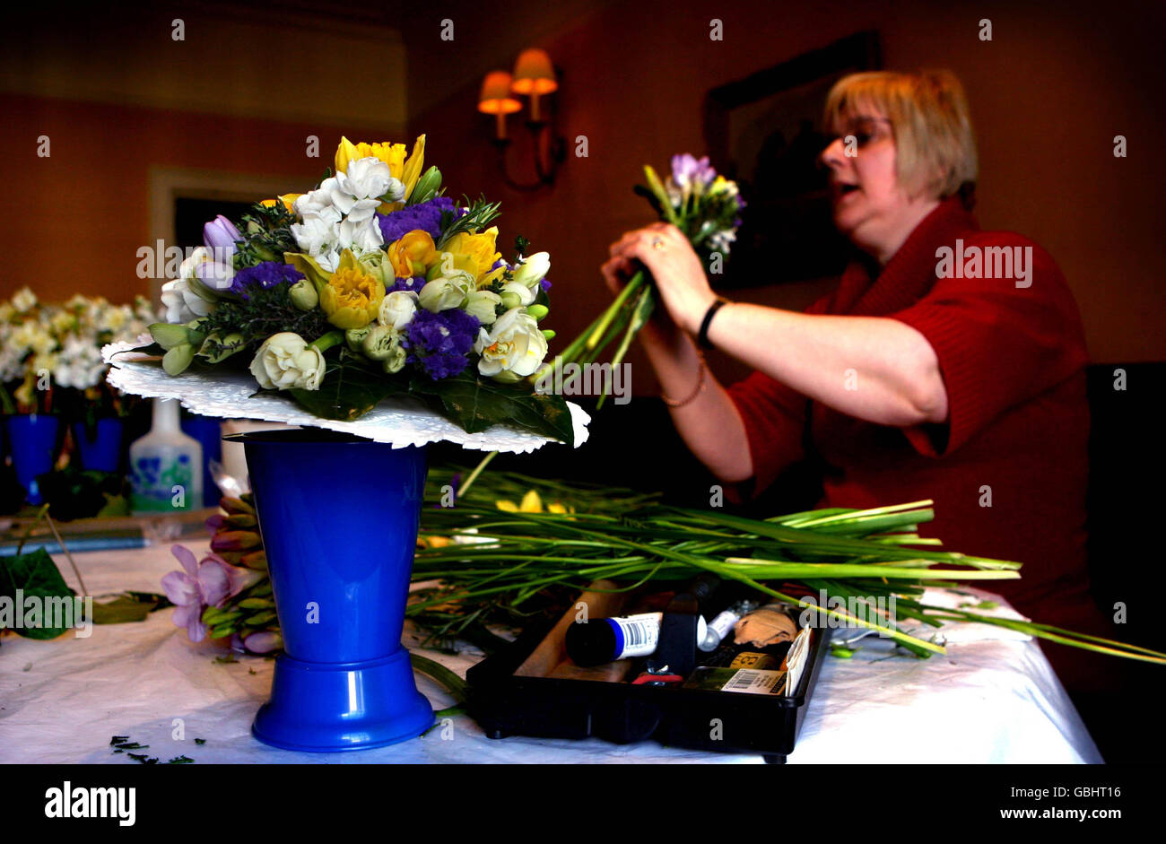 Rosie Mason, 55, the Royal Nosegay maker prepares the Queen's Nosegays at the Angel Hotel in Bury St Edmunds. The posies will be carried by the Royals during the Maundy Thursday Service at Bury St Edmunds Cathedral tomorrow, when Queen Elizabeth II will hand out Maundy coins. Stock Photo