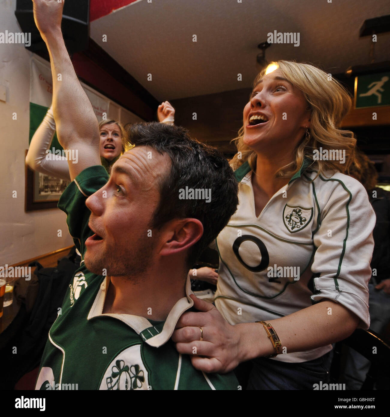Ireland rugby fans celebrate as their team score their first try in the final match of the RBS 6 Nations between Wales and Ireland in the Borough Arms pub near the Millennium